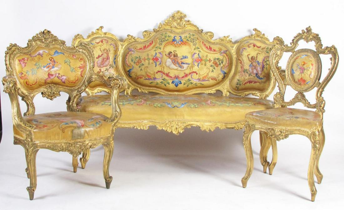 Three Piece French Parlour Suite: A French three-piece parlour suite, with carved wood frames with gold leaf finish, painted finish on vintage leather upholstery with cherubs, arm chair, side chair (needs tightened) and settee, settee