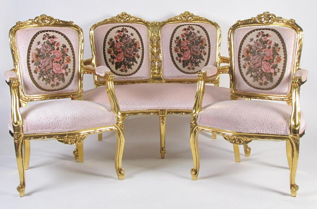 Three Piece Parlour Suite: A French style three piece parlor suite, with carved frames having gold leaf finish, including two arm chairs and settee, chair 38.5"h