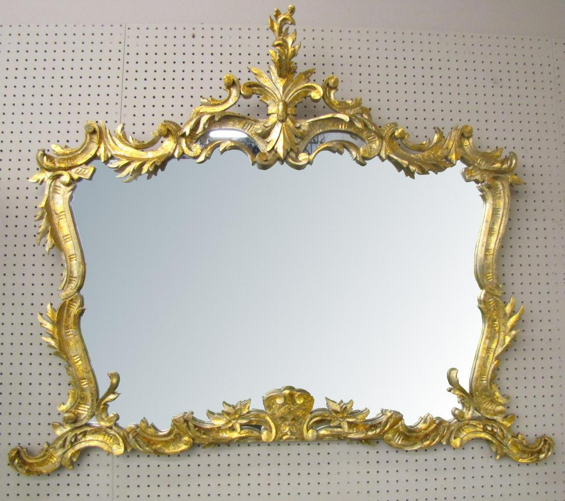 Fancy French Wall Mirror: A carved French wall mirror, leaf and swag motif, with gold leaf finish, 48" x 56"