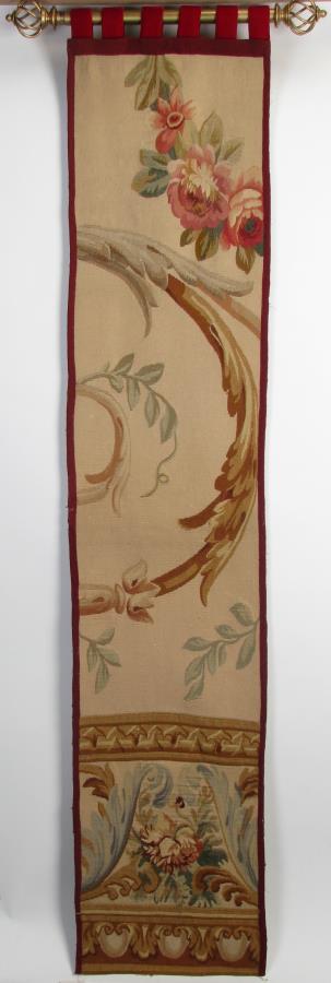 Aubusson Wall Tapestry: An Aubusson wall tapestry with tan field, red floral and gold and peacock blue, trimmed with a deep red border with tab top, gold finished rod, 71" x 14.5"