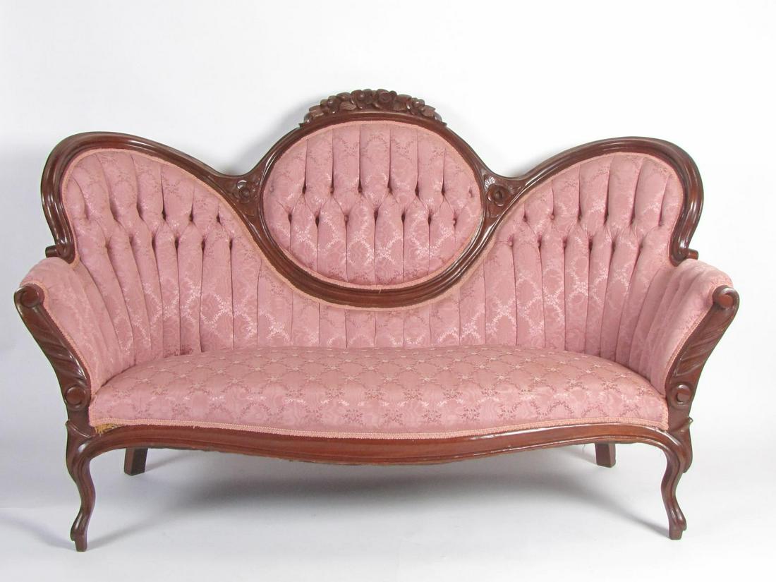 Victorian Style Settee: A Victorian style settee, with button tufted, silk upholstery, carved frame, with two small matching hassocks, 65"l
