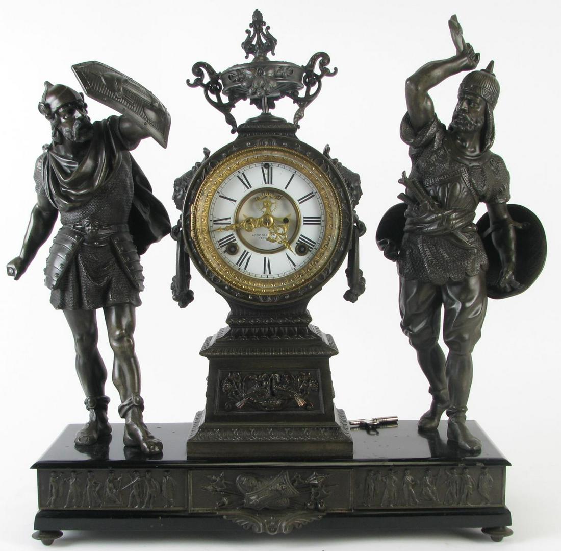Ansonia Figural Spelter Mantle Clock: Ansonia Figural Spelter Mantle Clock, clock flanked by two Turkish soldiers with shields and war axes (one missing), white clock face with roman numerals and beveled glass door, on black enameled base