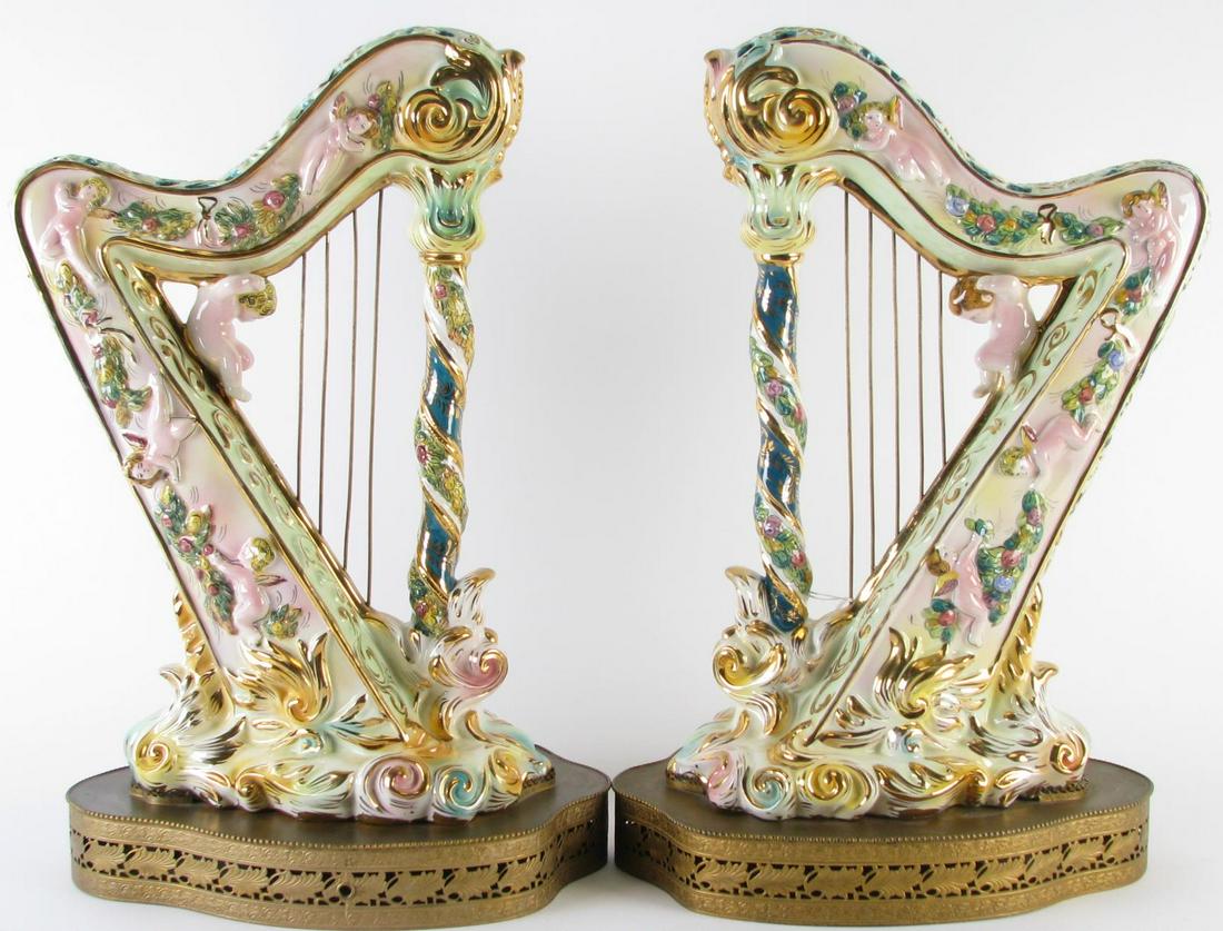 Pair of Italian Decorative Porcelain Harps: Pair of Italian Decorative Porcelain Harps, decorated with cherub figures and accented in gold, metal strings (smallest one missing on one harp), on fitted pierced metal stands, hallmarked on undersid