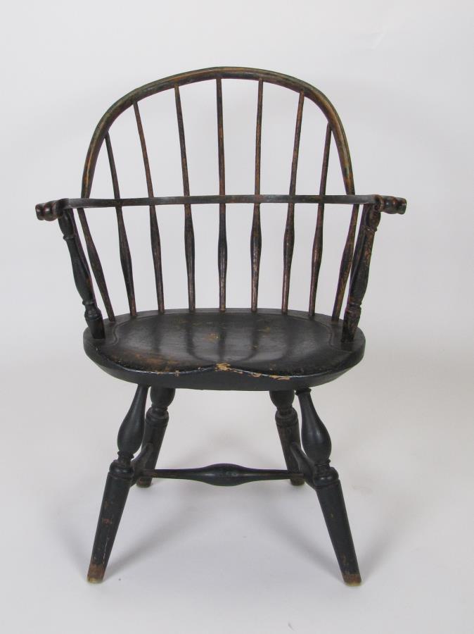 18th Century Windsor Arm Chair: A painted, 18th century Windsor arm chair, New England, ca 1760-1780, the crest rail above seven spindles, arms ending in curved knuckle hand holds on vase and ring turned supports, saddle seat, splay