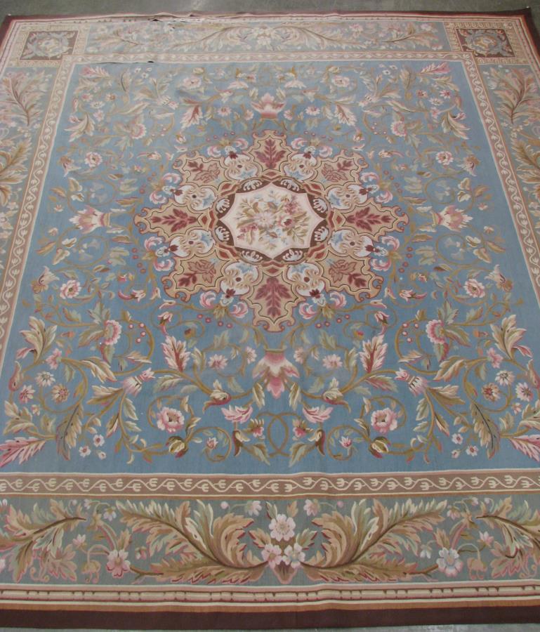 Hand Made Aubusson Room Size Rug: Hand Made Aubusson Room Size Rug, having a blue field with cream floral decorated center medallion, red and green floral decorated field, blue border with red, blue and green floral decoration, 11'8" 