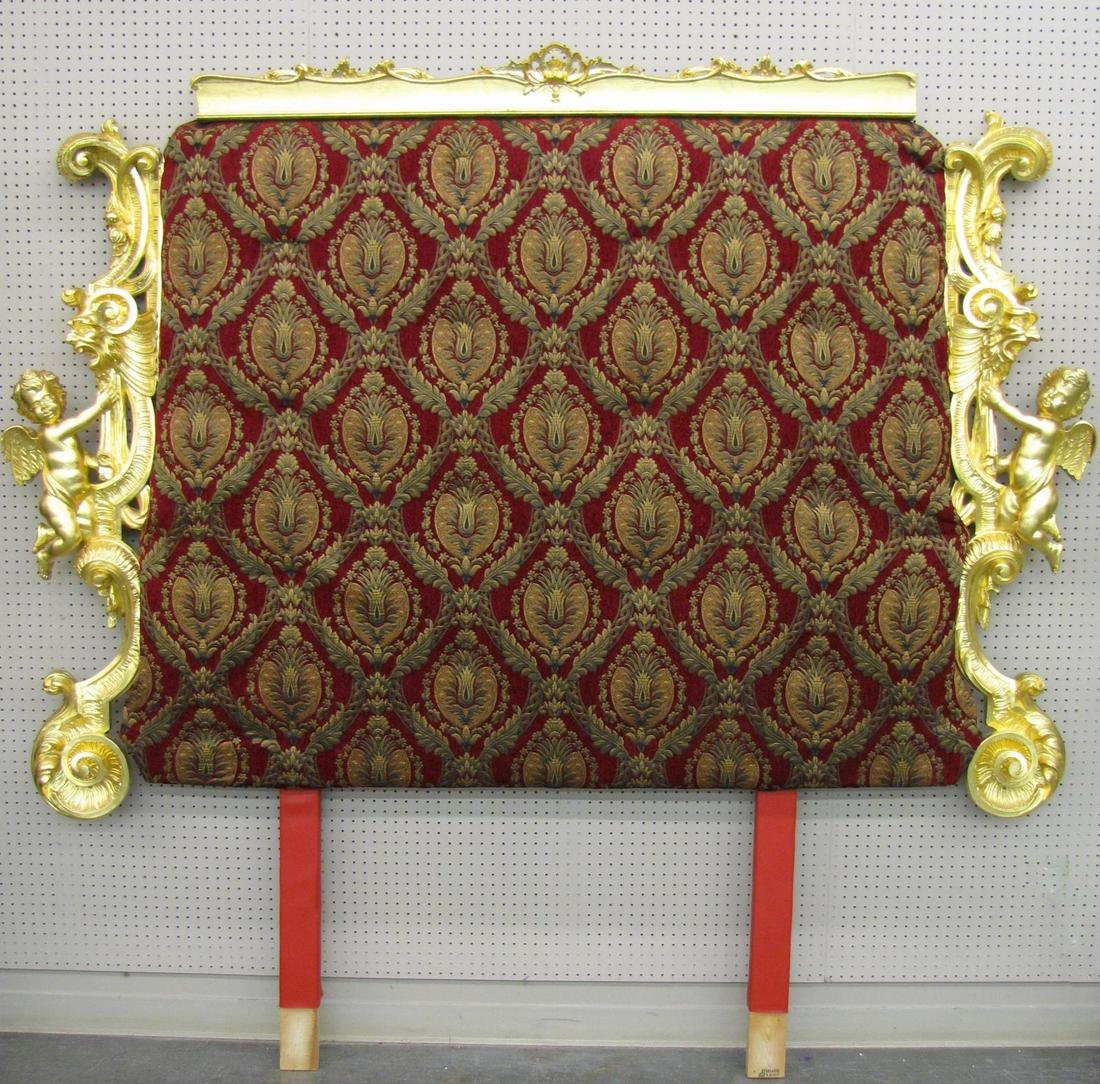Ornate Gold Leaf Carved Headboard: An ornately carved and gold-leaf headboard, king size, with cherub carvings and portrait carvings, with maroon upholstery, 92"h (this was the headboard in Rev Hicks' room)