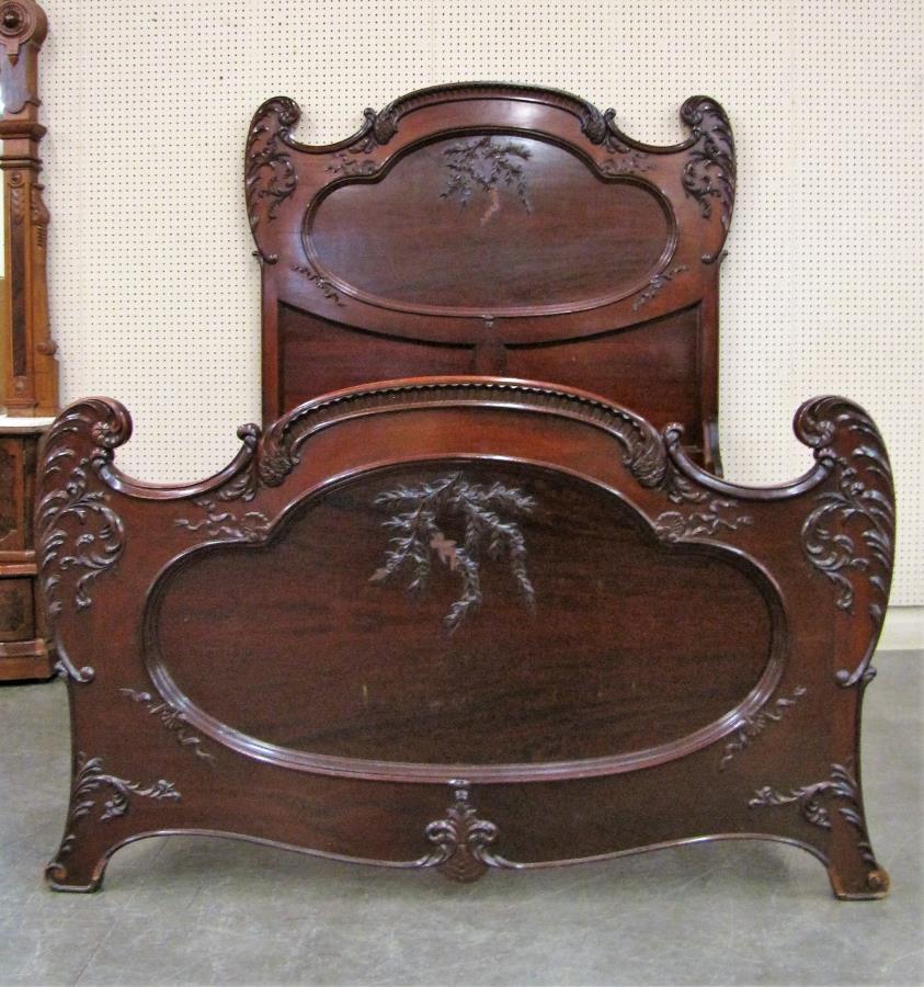 Late Victorian Mahogany Bedroom Group: A late Victorian mahogany bedroom group, including full size panel bed, washstand with mirror, dresser with mirror, and single door mirrored armoire, with raised panel carvings, (bed is missing decora