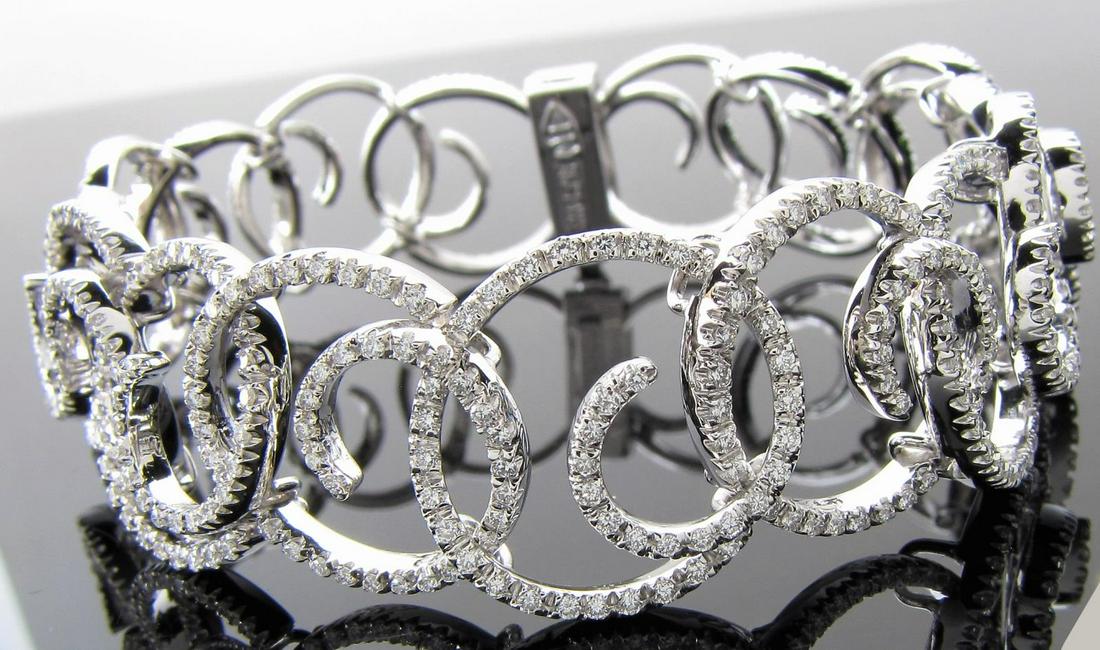 18K White Gold Stefan Hafner Diamond Bracelet: 18 karat white gold diamonds spiral design bracelet designed by Stephen Hafner. The bracelet contains round brilliant cut diamonds totaling approx. 6.0 carats total, and graded G-H in color SI in clar