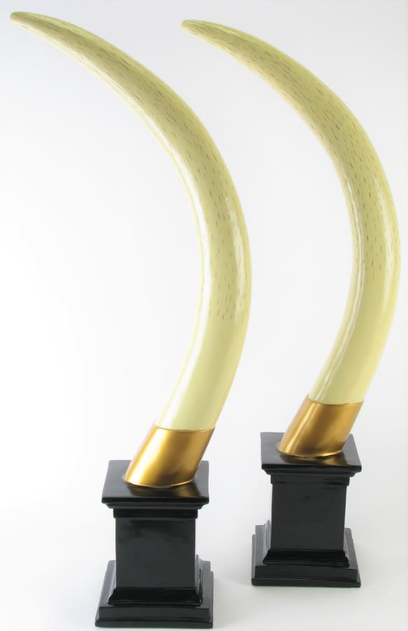 Pair of Design Toscano Faux Tusk Trophies: Pair of Design Toscano Faux Tusk Trophies, composite elephant tusks with cream and gold painted finish, affixed to black pedestals, 32' high