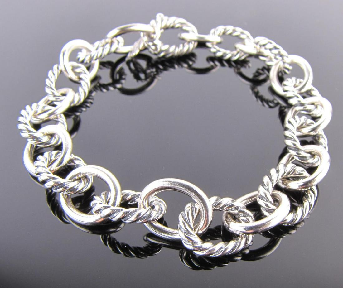 David Yurman Sterling Medium Oval Link Bracelet: A David Yurman sterling silver, medium oval link bracelet, 10mm wide, lobster clasp, inspired by classical and original motifs and meticulously crafted by artisans, the oval link bracelets are "...des