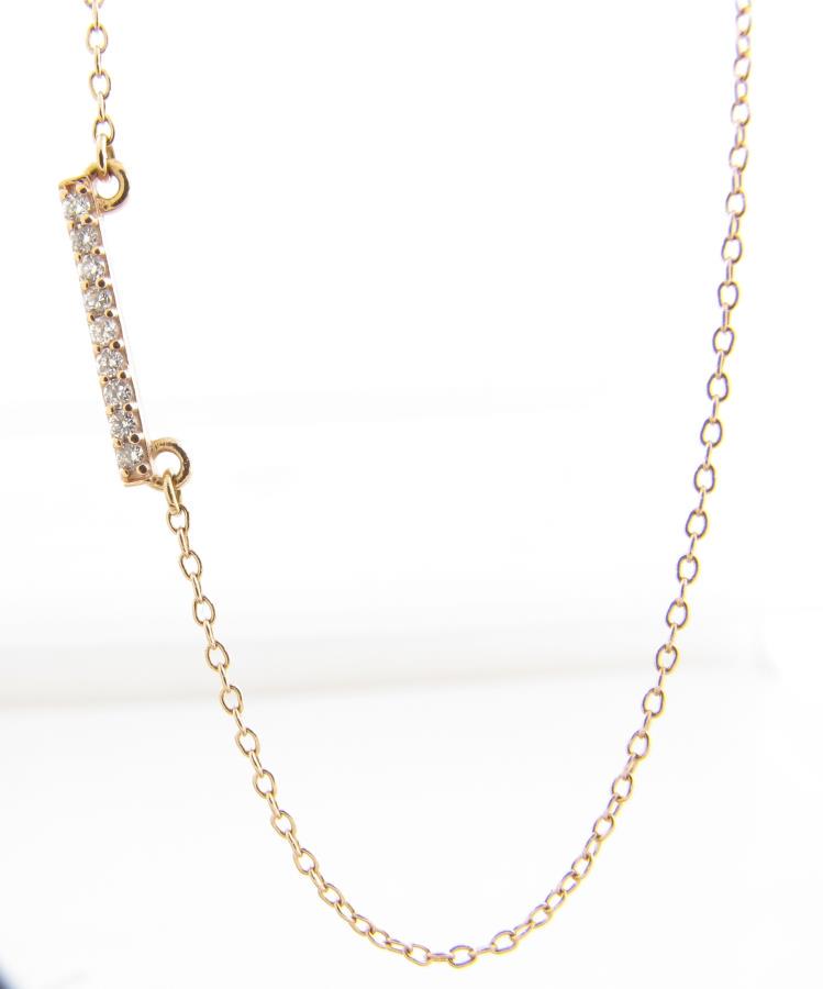 14K Rose Gold Diamond Bar Necklace: A 14K rose gold necklace featuring a fixed .50 inch long bar pendant with nine round white diamonds equaling approximately 1dwt; pendant set in offset design; necklace is 20 inches long and weighs 1dw