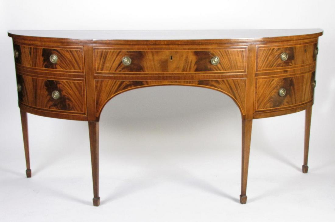 Hepplewhite Style Mahogany Sideboard: A Hepplewhite style mahogany sideboard, with burl veneer and inlaid banding, one center drawer and two cabinet doors, 20th century, on tapered square legs, 71" x 23" x 35"h