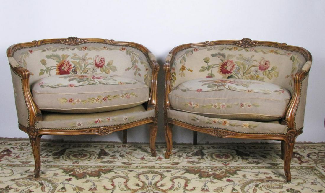 Pair of Louis XV Style Settees: A pair of Louis XV style settees, walnut frames, with loose cushions, tapestry style upholstery nailhead trim, floral carvings, ca early 20th century, 39" x 26" x 32"h