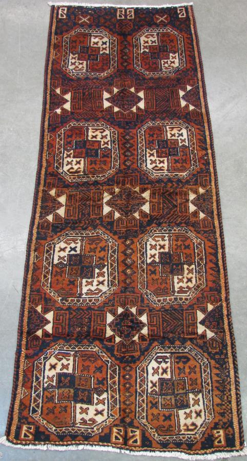 Handmade Shiraz Runner Rug: Handmade Shiraz Runner Rug, having a navy blue field with blue, cream and rust repeating medallion decoration, tan and rust border, white fringe at ends, 11'5" x 4'