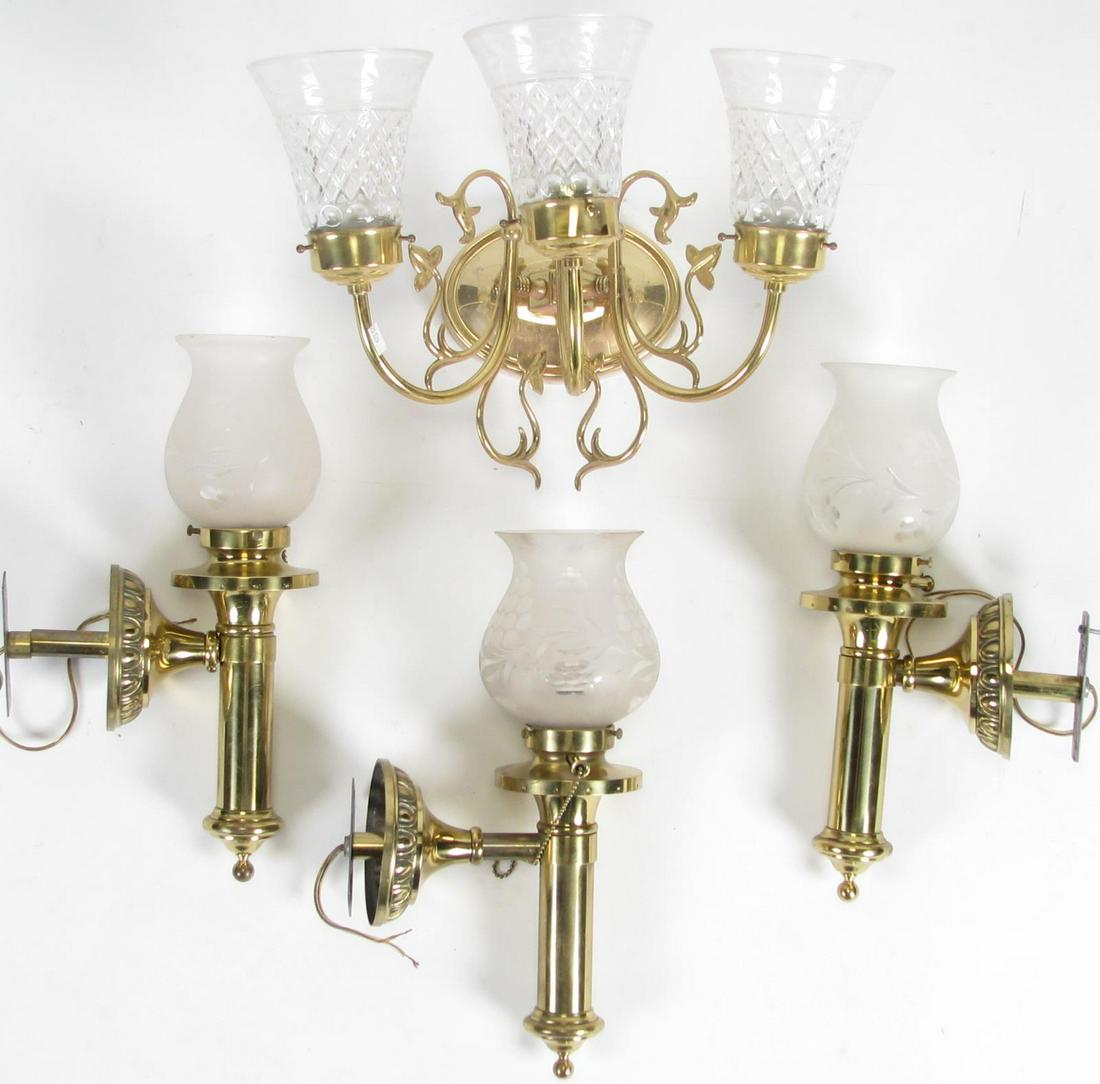 Group of Brass Wall Sconces: A group of brass wall sconces, including (1) three-light with etched glass shades; (3) single light with etched, frosted glass shades; 15"h