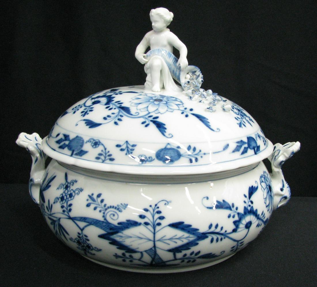 Meissen Blue Onion Lidded Tureen: A Meissen Blue Onion lidded tureen with figural lid depicting child with cornucopia of flowers, crossed swords mark, bowl measures 10" diameter, 12" handle to handle, hairline crack in bowl, previous