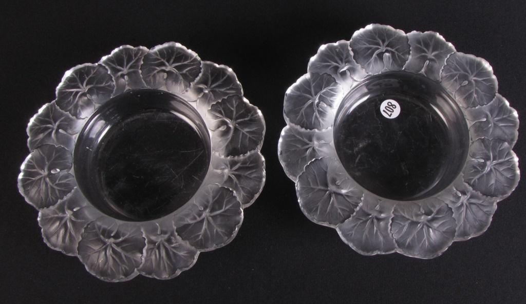 Two Lalique Honfleur Wine Bottle Coasters: Two Lalique Honfleur wine bottle coasters, each measuring 8.5" diameter and 2" high; one marked Lalique France in block letters and one marked Lalique Cristal in block letters (a few small chips on ea