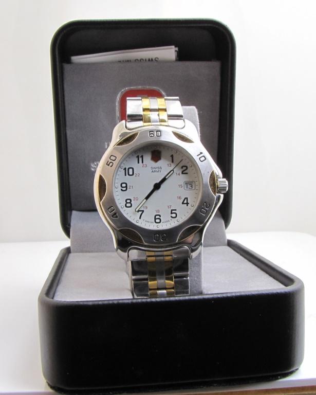 Swiss Army Watch: A Swiss Army Officer's Watch, Stainless Steel, white dial, black Arabic Numbers, Logo at 12 o'clock, date at 3 o'clock, round 42mm case, quartz movement, stainless steel case with gold tone accents at