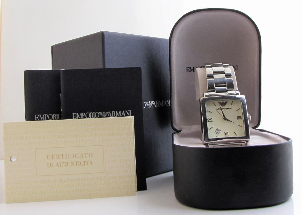 Emporio Armani AR-5306 Watch: An Emporio Armani AR-5306 tank style quartz watch with 34mm square steel case, ivory dial, silver tone Dauphine hands, silver tone stick and Roman numeral hour markers, date at 7 o'clock, on triple li