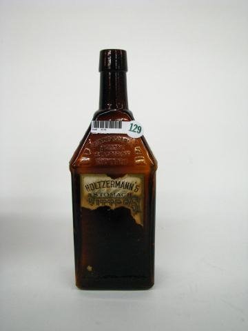 Antique Holzermann's Stomach Bitters Bottle: Antique bitters bottle, Holzermann's Stomach Bitters, log cabin style, partial label, amber, 10" high, scratch on rim (see photo)