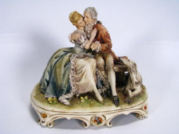 Antonio Borsato Romantic Couple #767: Antonio Borsato #767 Romantic Couple, 7" Gres figural grouping depicting romantic couple sitting on bench with Irish Wolfhound at side, damage to one flower inset in base?? - see photo