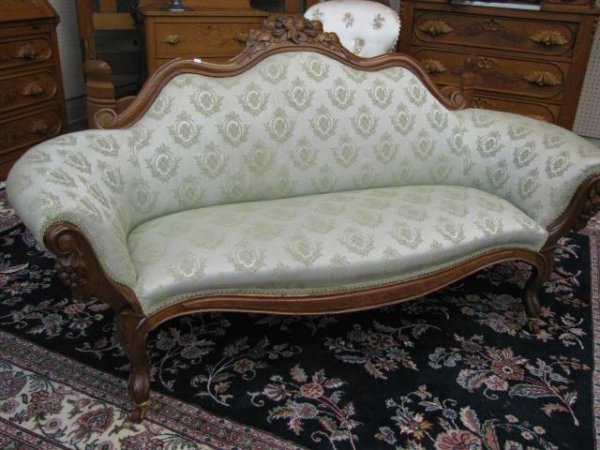 Carved Victorian Style Settee: Carved Victorian style settee, oak frame with acorn carvings, serpentine front, padded upholstered seat, back and arms, with French style silk upholstered, some light staining
