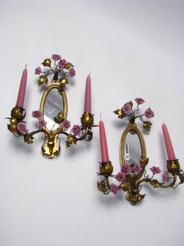 Pair of Floral Motif Mirrored Candle Sconces: Pair of floral motif mirrored candle sconces, with oval mirrored back, 12.5" high x 10" wide, with two-branch candle holders, cast metal frame, in leaf motif, with lavender, ceramic roses (one rose
