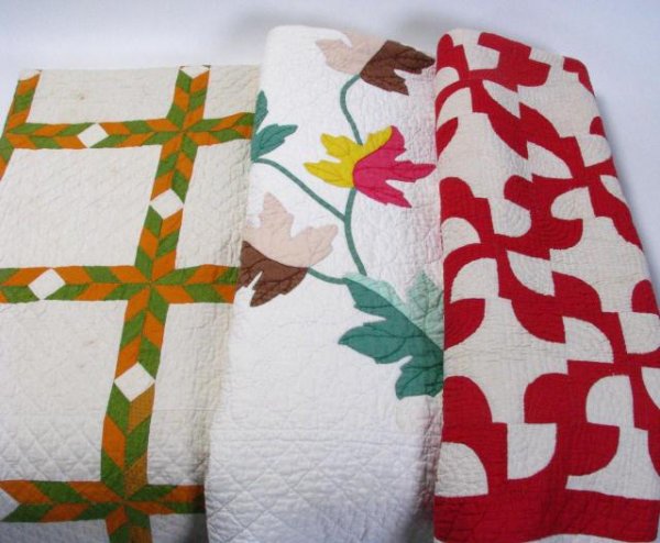 Three Antique Pattern Quilts: Three antique pattern quilts, all full size, one with autumn leaf decoration, small stain, one with geometric blocks, and red and white with alternating puzzle pieces