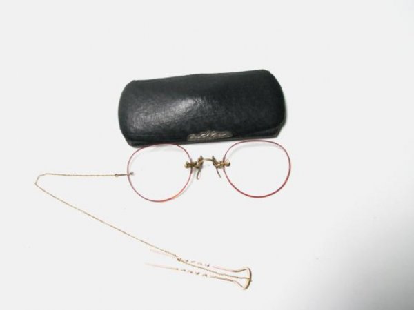 Pair of Lady's 14K Gold and Tortoiseshell Glasses: Pair of lady's 14K yellow gold glasses (marked on bridge) with tortoise shell frames, with gold hair clip attached via fob, includes original case