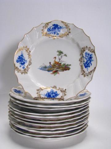 The Hague Dutch Faience Hand Painted Plates: Set of twelve 9.5" diameter The Hague, Holland Faience plates, hand painted, depicting various birds in landscape with cobalt and gold floral accents, with stork mark on bottom, all pieces