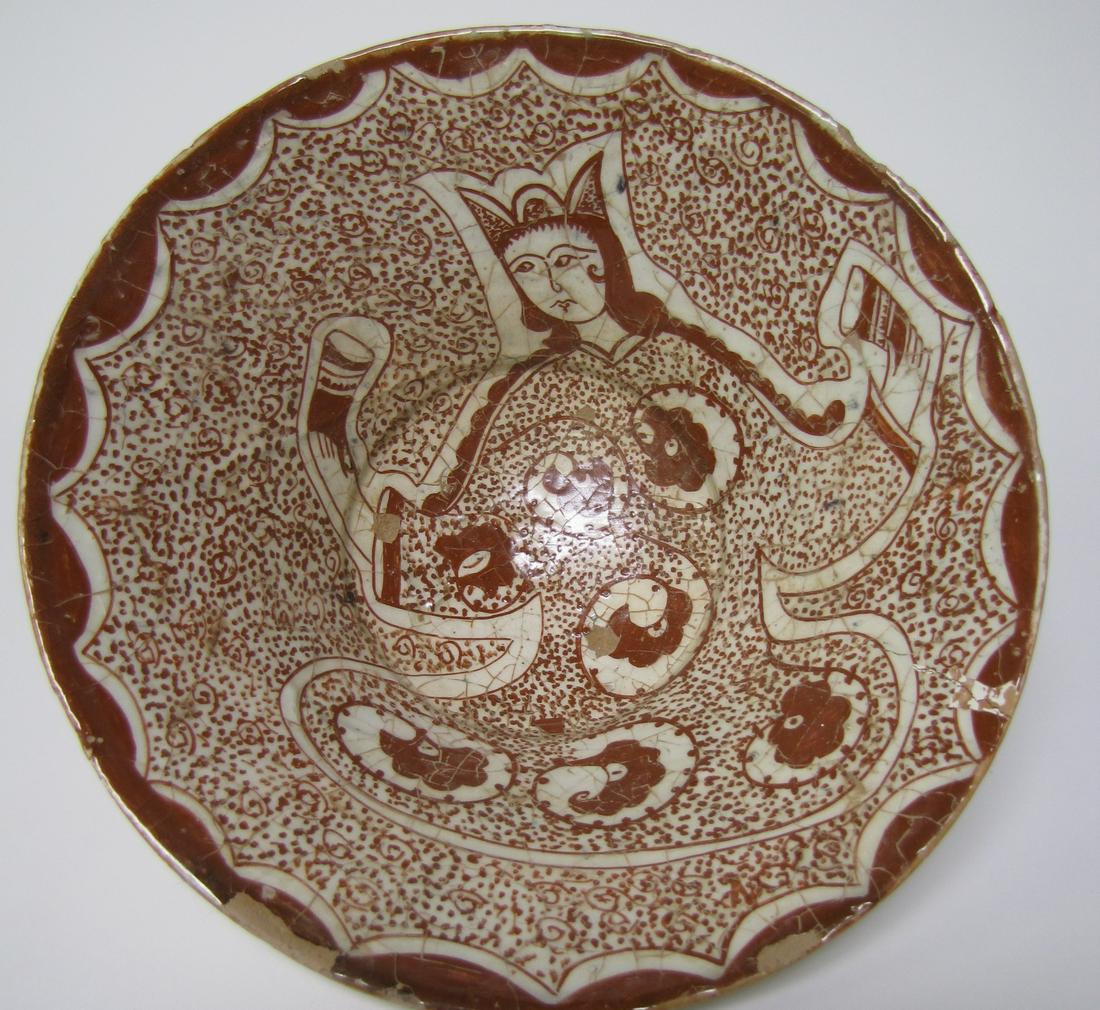 16th Century Afghan Stoneware Dish: An antique, circa 16th century, Afghan stoneware dish originating from the Herat-Mazersherif region of W. Afghanistan. A brown and white under-glazed stoneware dish with flared sides and raised foot,