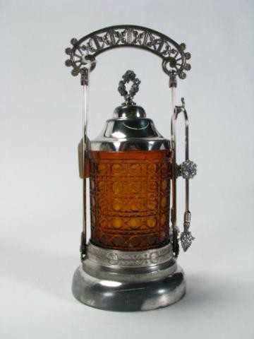 Antique Silverplate, Amber Glass Pickle Caster Set: Acme Silver Plate Co., quadruple silver plate and amber pattern glass pickle caster, with lid and tongs, canister has chips and roughness on bottom and on rim