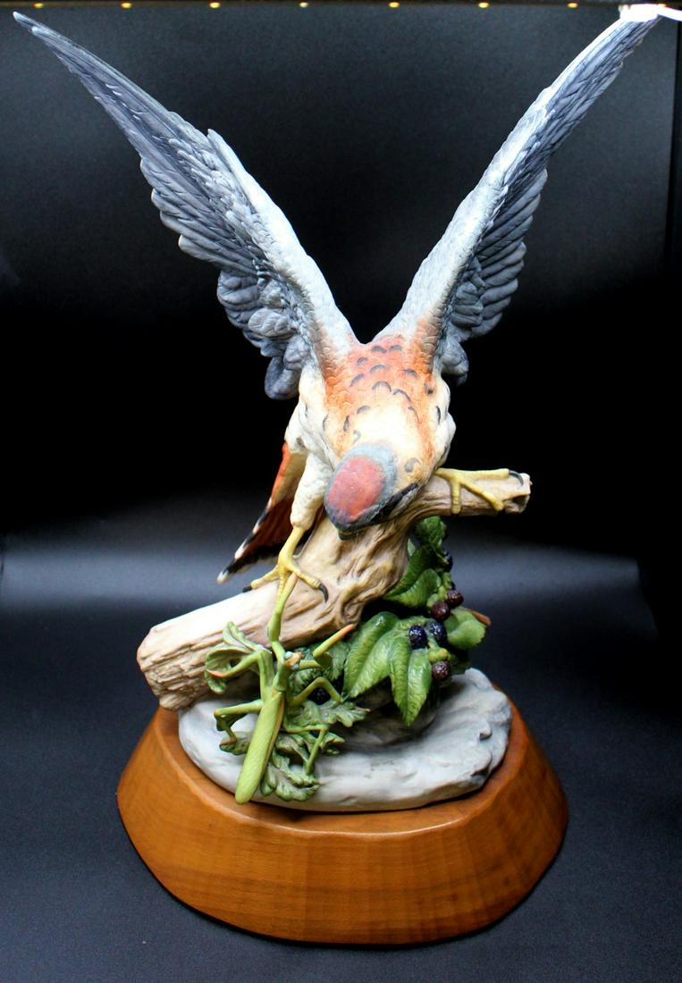 Cybis Kestrel Figural Grouping: A limited edition Cybis "Kestrel" depicting a Kestrel (small falcon) and a praying mantis on berry plant. This is #64 of 175 and measures 18" overall height. The grouping measures 16" tall and is affi
