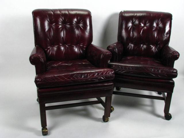 Pair of Leather Office Guest Chairs: Pair of leather office guest chairs, Chinese Chippendale style, wood base, on castors, nail head trim, red wine leather upholstery, both show minor wear from normal use