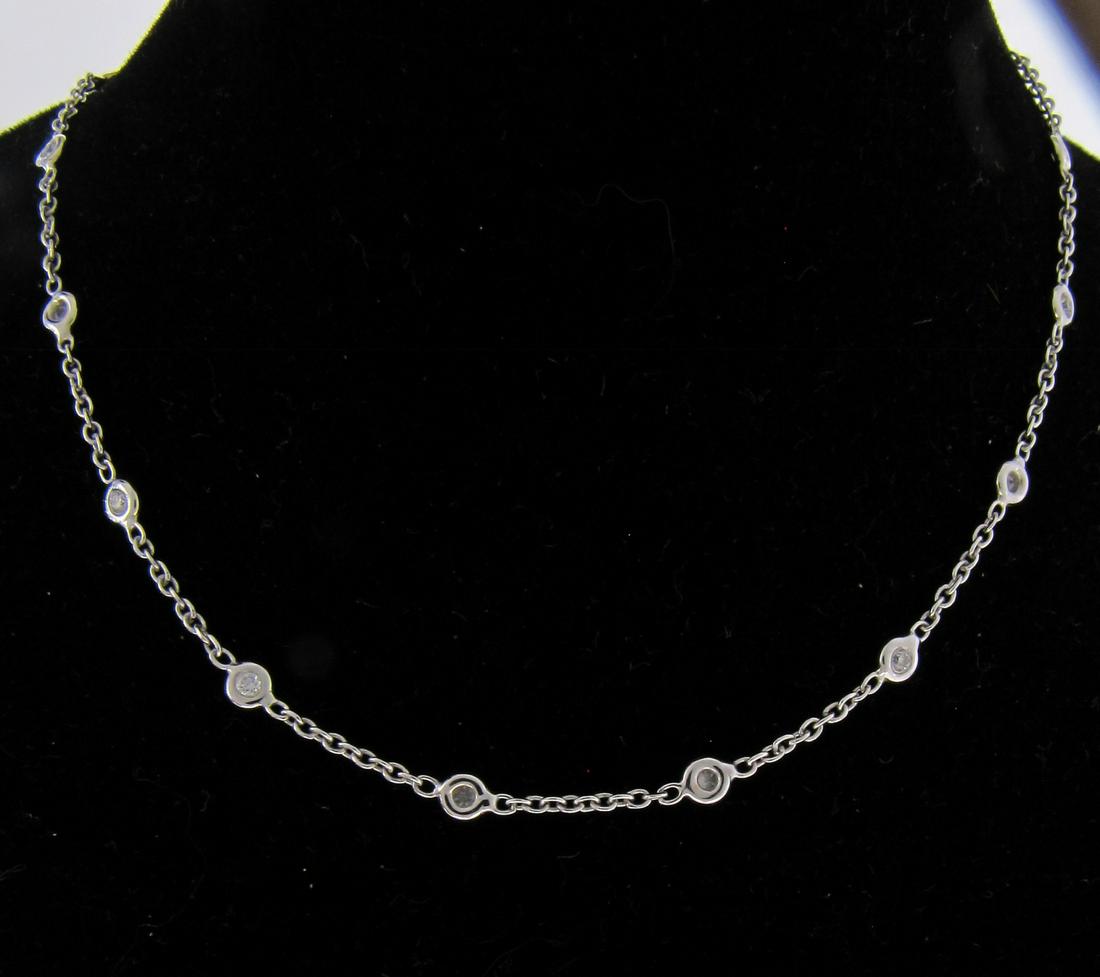 18K White Gold Diamond By The Yard Anklet: An 18K white gold anklet by Diamond by the Yard, with sixteen bezel set diamonds weighing approximately .24ctw, 9" long