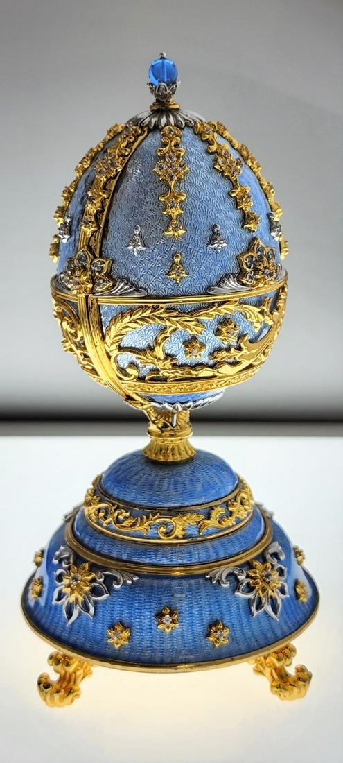 "Fountain of Jewels" Faberge Franklin Mint Egg: Franklin Mint House of Faberge egg music box, "The Peter Carl Faberge 150 Anniversary Imperial Egg Fountain of Jewels". Crafted of sterling silver with 24KT gold accents, white sapphires and blue guil