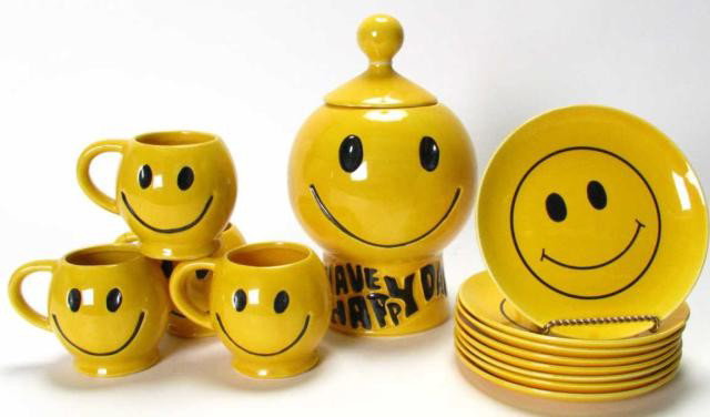 McCoy 'Have a Happy Day' Cookie Set: McCoy 'Have a Happy Day' Cookie Set including a lidded cookie jar, eight 7.5" plates, and four mugs, one with repaired handle