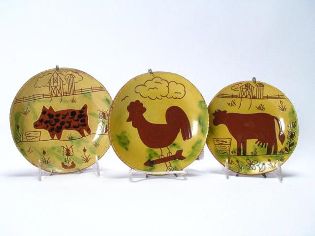 Three Breininger Animal Theme Red Ware Plates: Three Lester Breininger Pennsylvania Red Ware Pottery decorator plates, all signed and dated verso, with weather notation, depicting Rooster, Dairy Cow and a pig