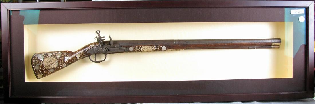 17th Century Presentation Snaphaunce Flintlock: A late 17th century Snaphaunce type flintlock youth rifle, presentation stock elaborately decorated with inlaid mother of pearl and ivory inlay, only 31" overall length, likely English made, this type