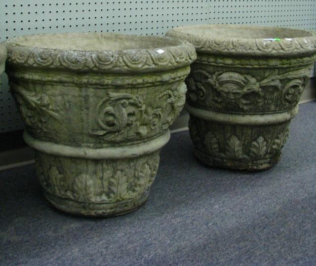 Pair Ornamental Concrete Planters: Pair of cast ornamental concrete planters, 19 inches high, 22 inches diameter, with leaf and mask motif casting