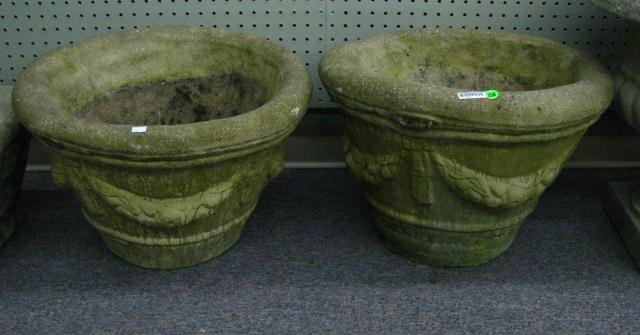 Pair of Ornamental Concrete Planters: Pair of cast ornamental concrete planters, 14 inches high, 19 inches diameter, with swag and jabot decoration