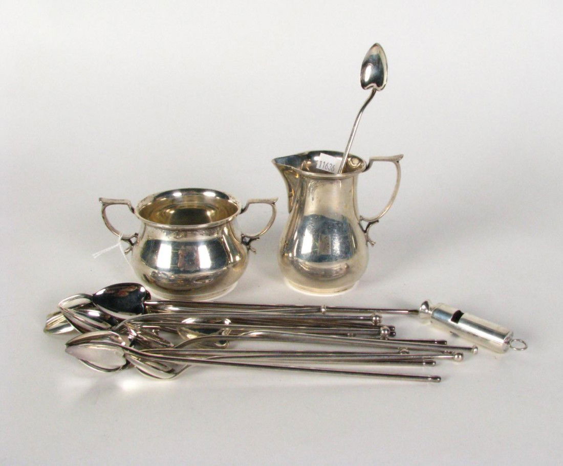 Lot of Sterling Silver Table Accessories: Lot of Sterling Silver Table Accessories, cream and sugar set, sixteen ice tea spoons with heart shaped bowl, a whistle