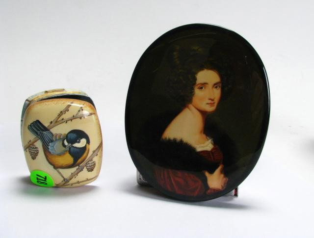 Two Russian Enameled Boxes: Two Russian Enameled Boxes including black lacquer oval portrait box with red interior, and miniature hinged box by "Fedoskino", depicting bird on a branch