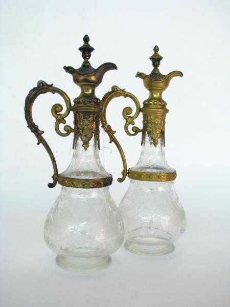 Pair of Etched Crystal Ewers: Pair of Etched Crystal Ewers with ornate cast metal handle and spout, body has a dragon and urn motif, 14" tall