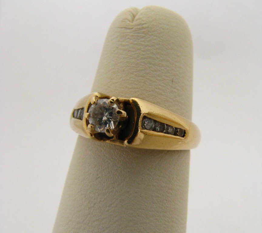 14K Yellow Gold Lady's Diamond Ring: 14K Yellow Gold Lady's Diamond Ring with one prong set solitaire, approximately .30ct, and eight channel set diamonds in mounting, size 5.5