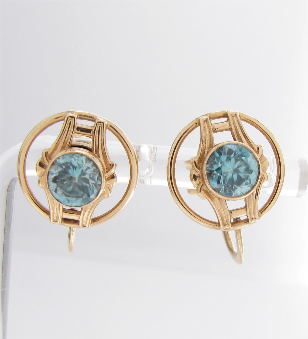 Pair of 10K Yellow Gold Earrings, Blue Tourmaline: A pair of 10K yellow gold, screw-back earrings, each with a bezel set, round blue tourmaline, 2.65dwt