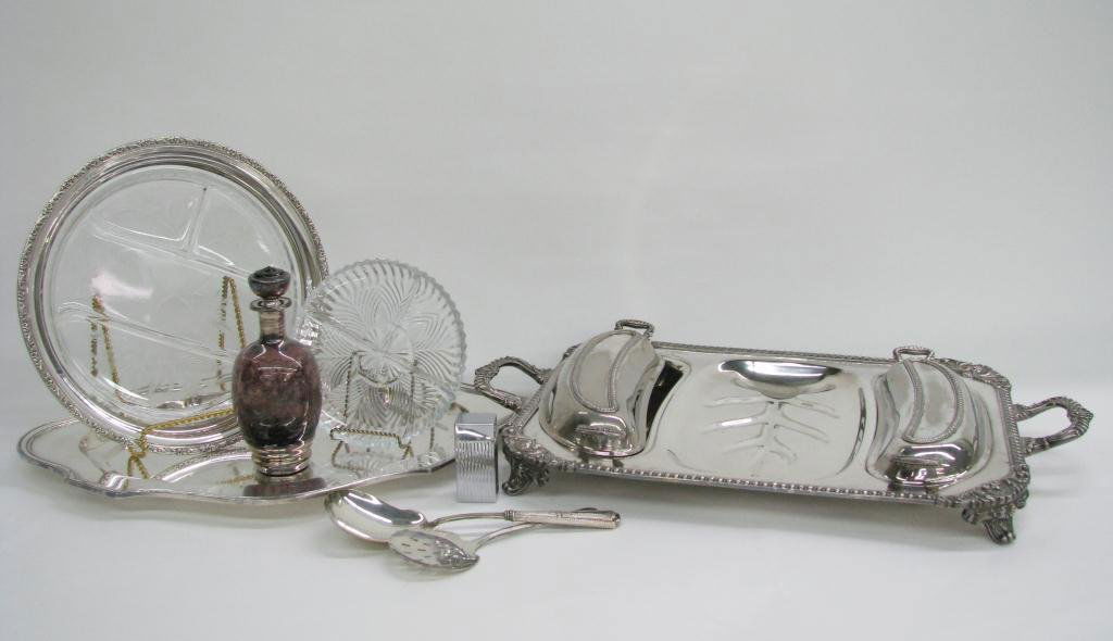 Group of Silverplate Table Accessories: Group of silverplate table accessories, including meat serving tray with covers, crystal divided plate, oval tray, two spoons, amethyst bottle, and Parker table lighter in box
