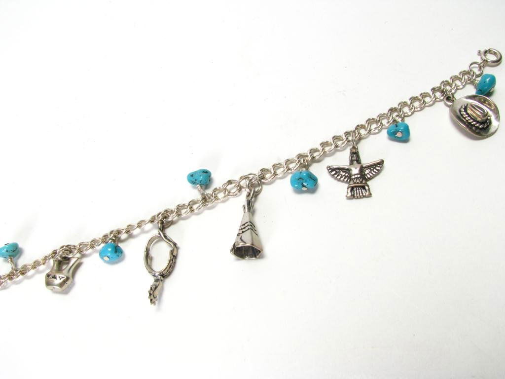 One Sterling Silver Charm Bracelet: One Sterling Silver Charm Bracelet, charms include cowboy hat, thunderbird, tipi, spur and native american pottery piece