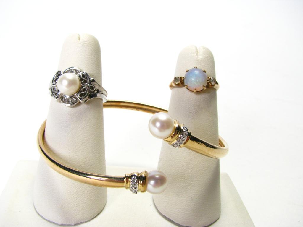Lady's 10k Bangle with Pearls, Two Rings: Lady's 10k yellow gold bangle with two pearls, 10k white gold ring with pearl, 10k yellow gold ring with opal (opal is cracked)