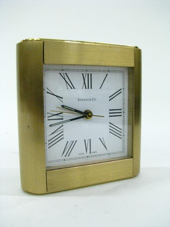 Tiffany and Co Brass Desk Clock: Tiffany and Co brass desk clock, white face with Roman numerals, 4.25x4 inches (some finish wear)